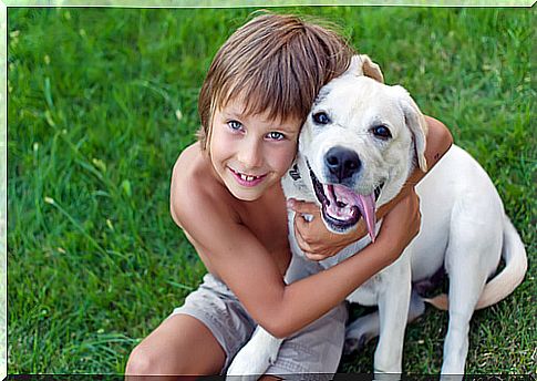 boy hugging dog